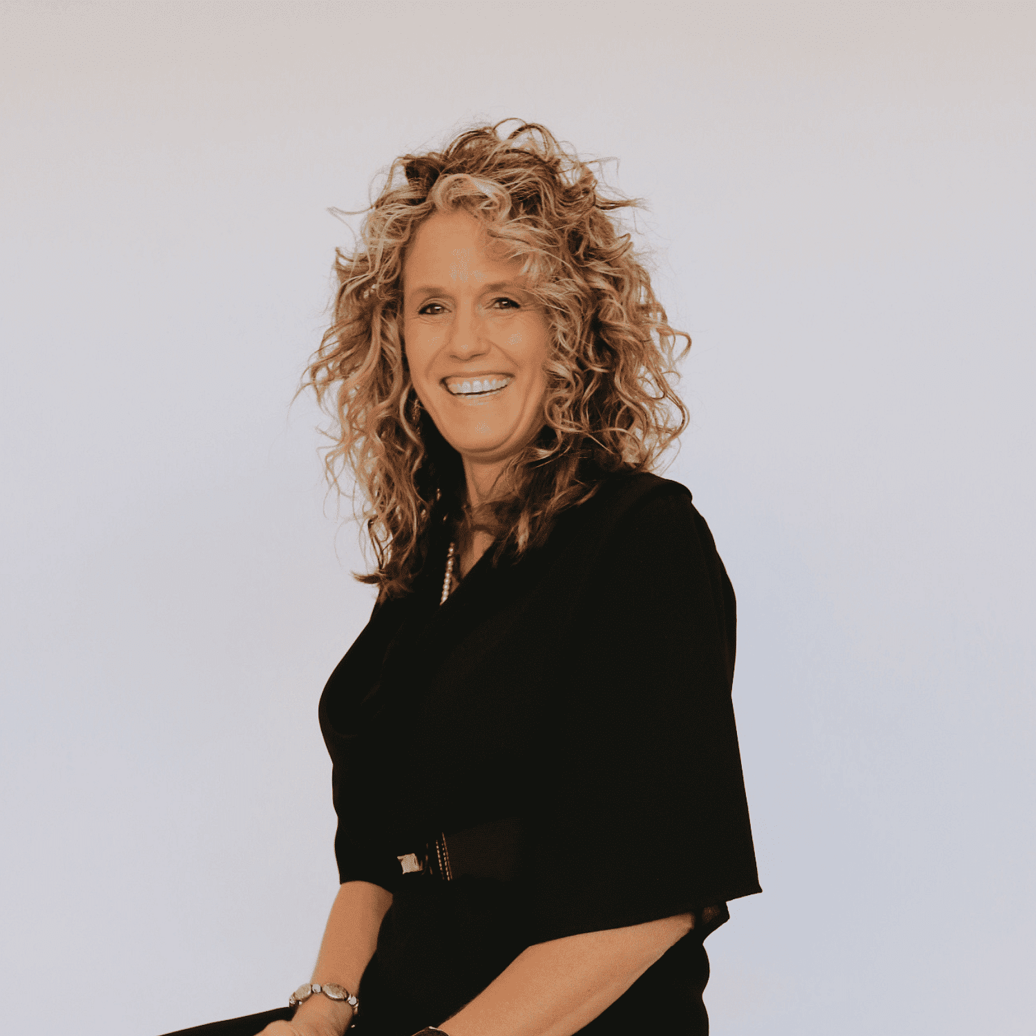 Portrait of Tina, a professional stylist at Shairon's Salon, showcasing their expertise and style.